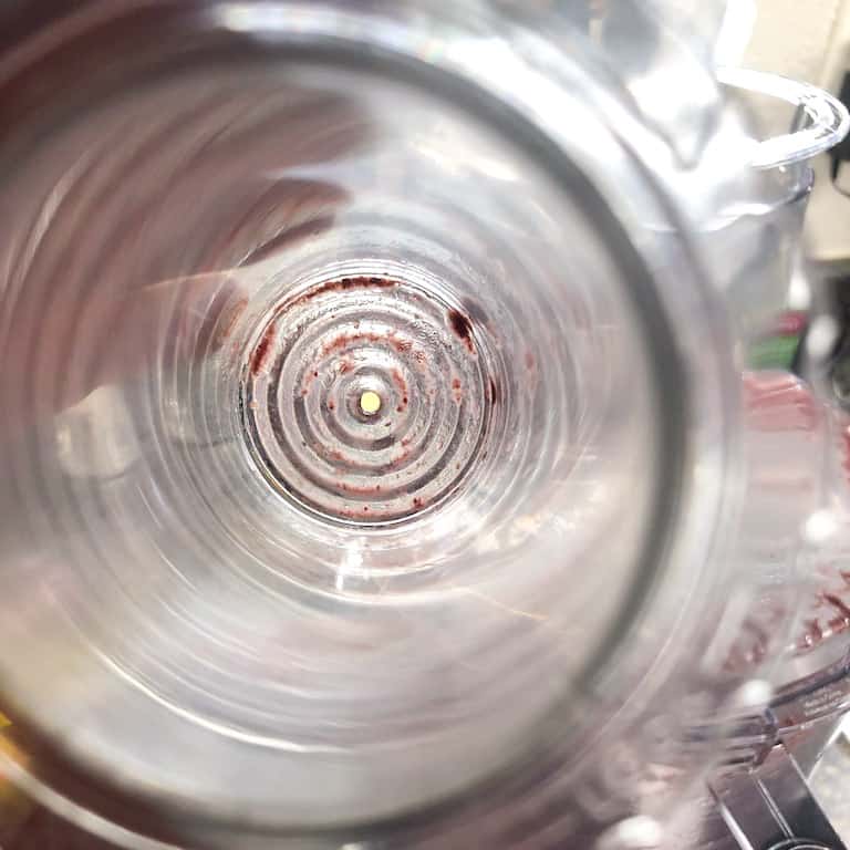 close-up view of hole in bottom of food processor pusher