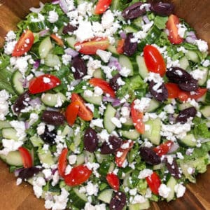 greek salad with chopped romaine, grape tomatoes, cucumber, kalamata olives, and feta