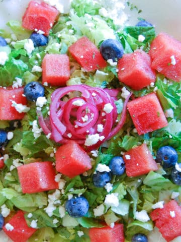 summer watermelon salad: chopped romaine, blueberries, diced watermelon, pickled red onions, and crumbled feta