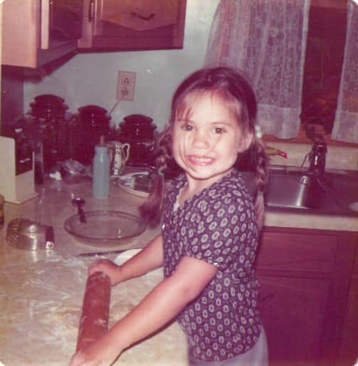 blog author at three years old rolling pie dough at kitchen counter